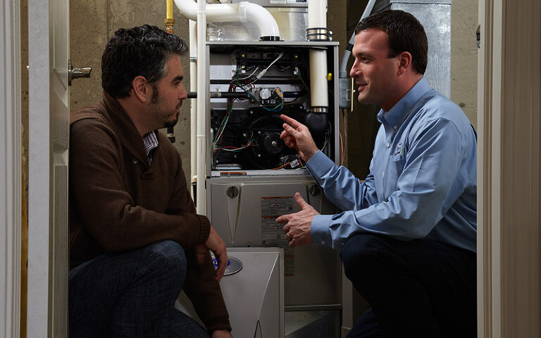 technician talking to homeowner about furnace