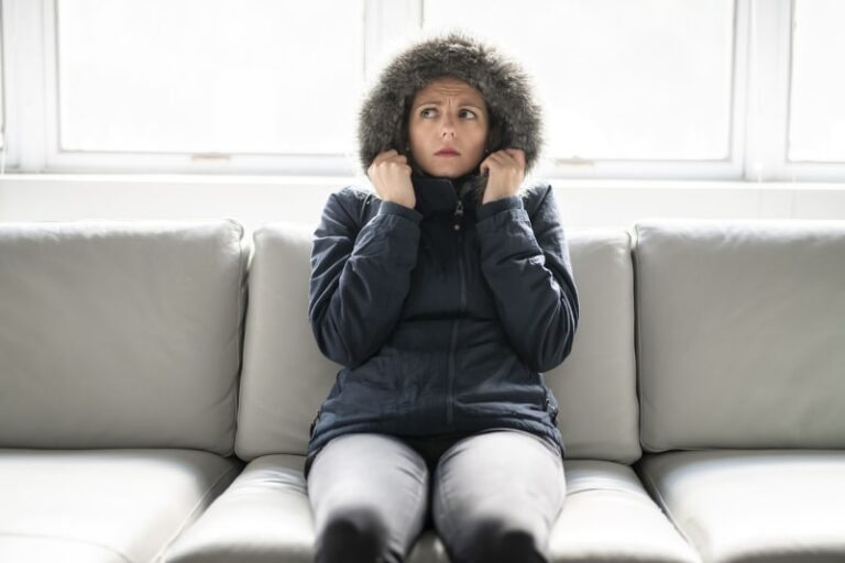 Woman In Coat On Couch