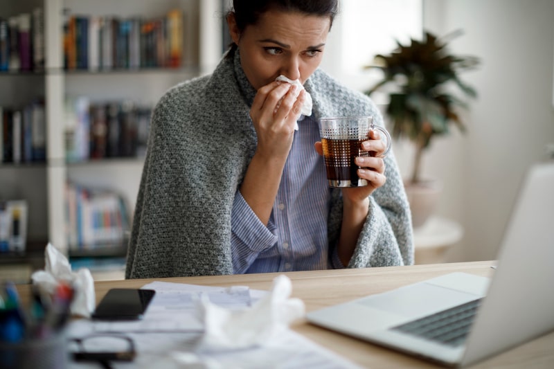Ill Woman With Tissues Working From Home