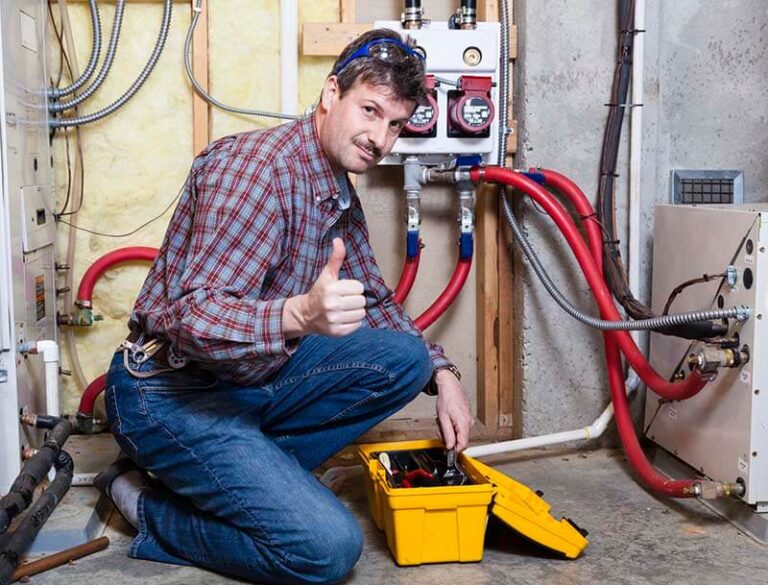 technician kneeling next to furnace